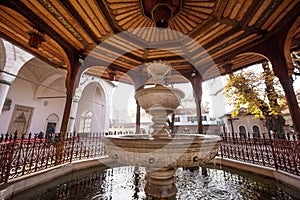 Mosque with fountain in front, with large glass building. High quality photo