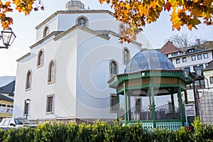 Mosque with fountain in front, with large glass building. High quality photo
