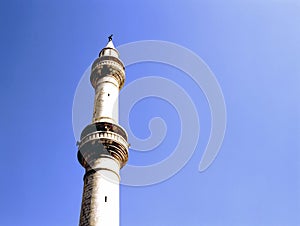 A mosque minaret against clear blue sky