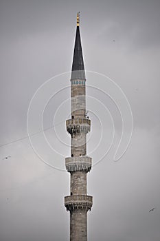 Mosque minaret and gray clouds