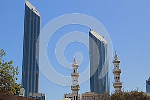 Mosque minaretes contrasted with modern skyscrapers photo