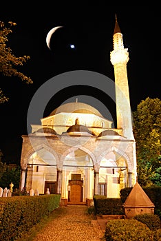 Mosque in night with crescent and star above