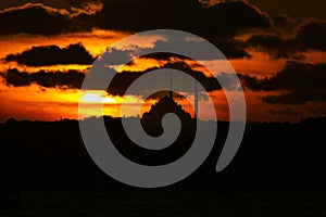 Mosque at sunset. Silhouette of Fatih Mosque and cloudy sky