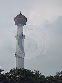 The mosque tower stands firmly in the blue sky