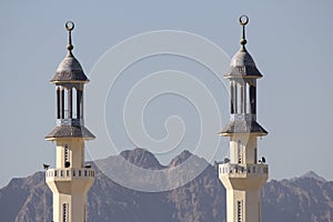 Mosque Towers Rise Above Mountains