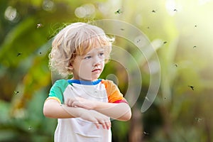 Mosquito on kids skin. Insect bite repellent photo