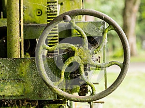 Moss covered farm machinery with handle