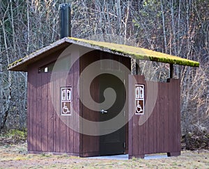 Moss covered Outhouse in Dense Forest