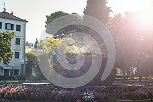 Moss covered stone fountain in the park Lujo Maruna in sunlight. Sibenik, Croatia photo