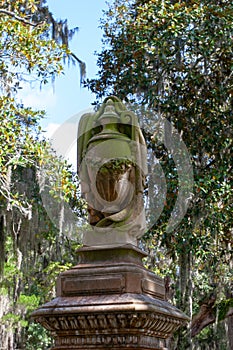 Moss covered urn grave marker