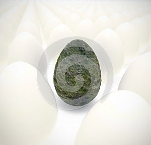 Moss green egg in rows of normal eggs - Easter time concept