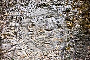 Moss-grown surface of the old stone cross