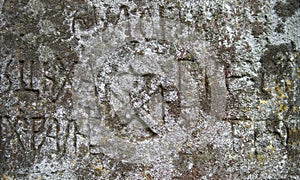 Moss-grown surface of the old stone cross