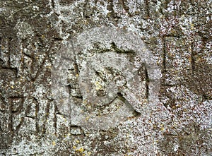 Moss-grown surface of the old stone cross