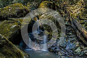 Mossy rocks with waterfall