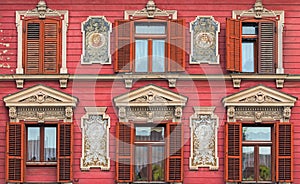 The most beautiful facade in Rotovz Town Hall Square in Maribor. Six windows with wooden shutters. The wall decorated by paintings