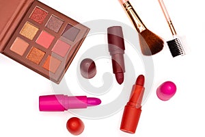 most classic lipsticks colours dark red, bright pink and vivid red and eye shadows on a white background