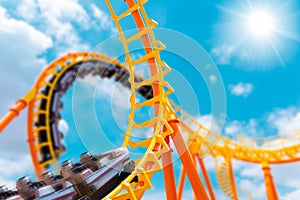 Most exciting roller coaster drive high to summer sky at theme park, people excited fun and joyful playing machine in holiday