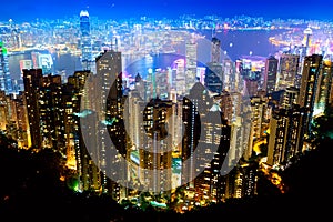 The most famous view of Hong Kong at twilight sunset. Hong Kong skyscrapers skyline cityscape view from Victoria Peak illuminated