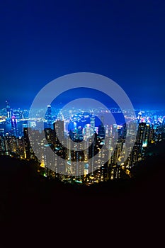 The most famous view of Hong Kong at twilight sunset. Hong Kong skyscrapers skyline cityscape view from Victoria Peak illuminated