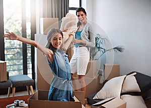 The most important package of all. an attractive young woman and her daughter moving into a new house.