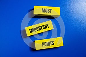 Most important points words written on wooden blocks with blue background