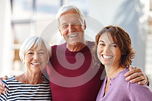 The most important women in my life. Portrait of a senior man standing beside his wife and daughter.