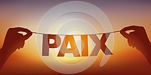 A garland featuring the word, peace in the setting sun.