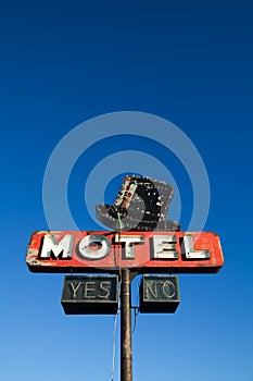 Motel sign against blue sky