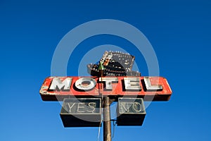 Motel sign against blue sky