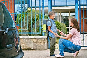 Mother accompanies child to school. mom encourages the student to accompany