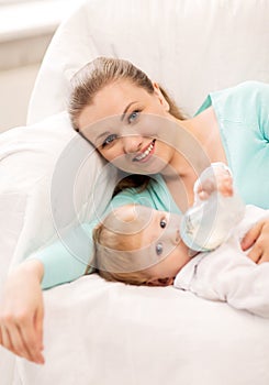 Mother and adorable baby with feeding-bottle