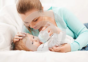 Mother and adorable baby with feeding-bottle