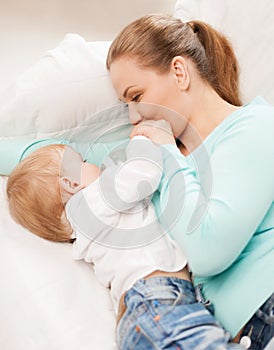 Mother and adorable baby with feeding-bottle