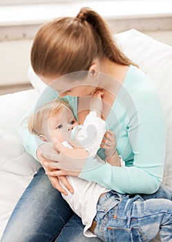 Mother and adorable baby with feeding-bottle