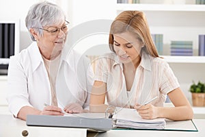 Mother and adult daughter doing paperwork