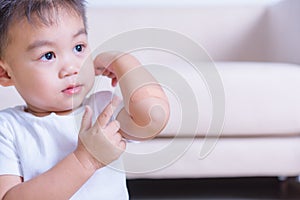 After mother applying adhesive plaster bandage on childen kid arm wound