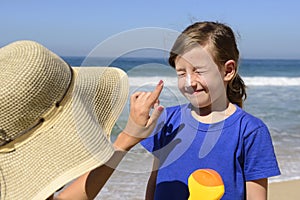 Mother applying sunscreen