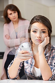 Mother Arguing With Daughter Over Use Of Mobile Phone