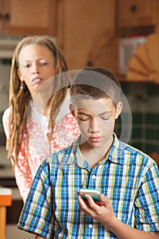 Mother attempts to peek as teen son checks his mobile phone