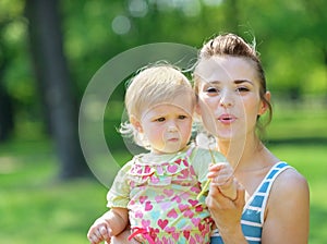 Mother and baby blowing away dandelion