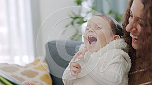 Mother, baby and bonding while reading a book in the living room with a smile, laughing and happiness. Learning