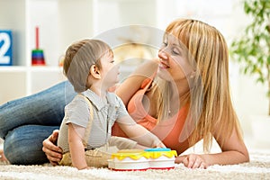 Mother and baby boy having fun with musical toys