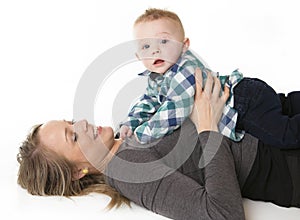 A mother with the baby boy on studio white background