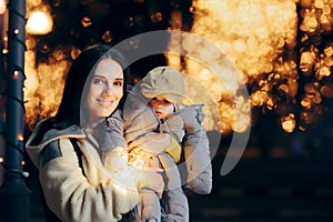 Mother and Baby Celebrating Christmas enjoying Street Lightning