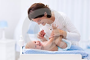 Mother and baby on changing table photo