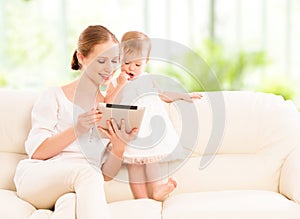 Mother and baby child with tablet computer