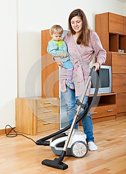 Mother with baby cleaning home