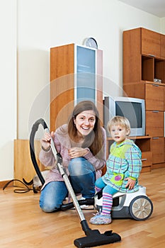 Mother with baby cleaning home