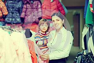 Mother with baby at clothes store